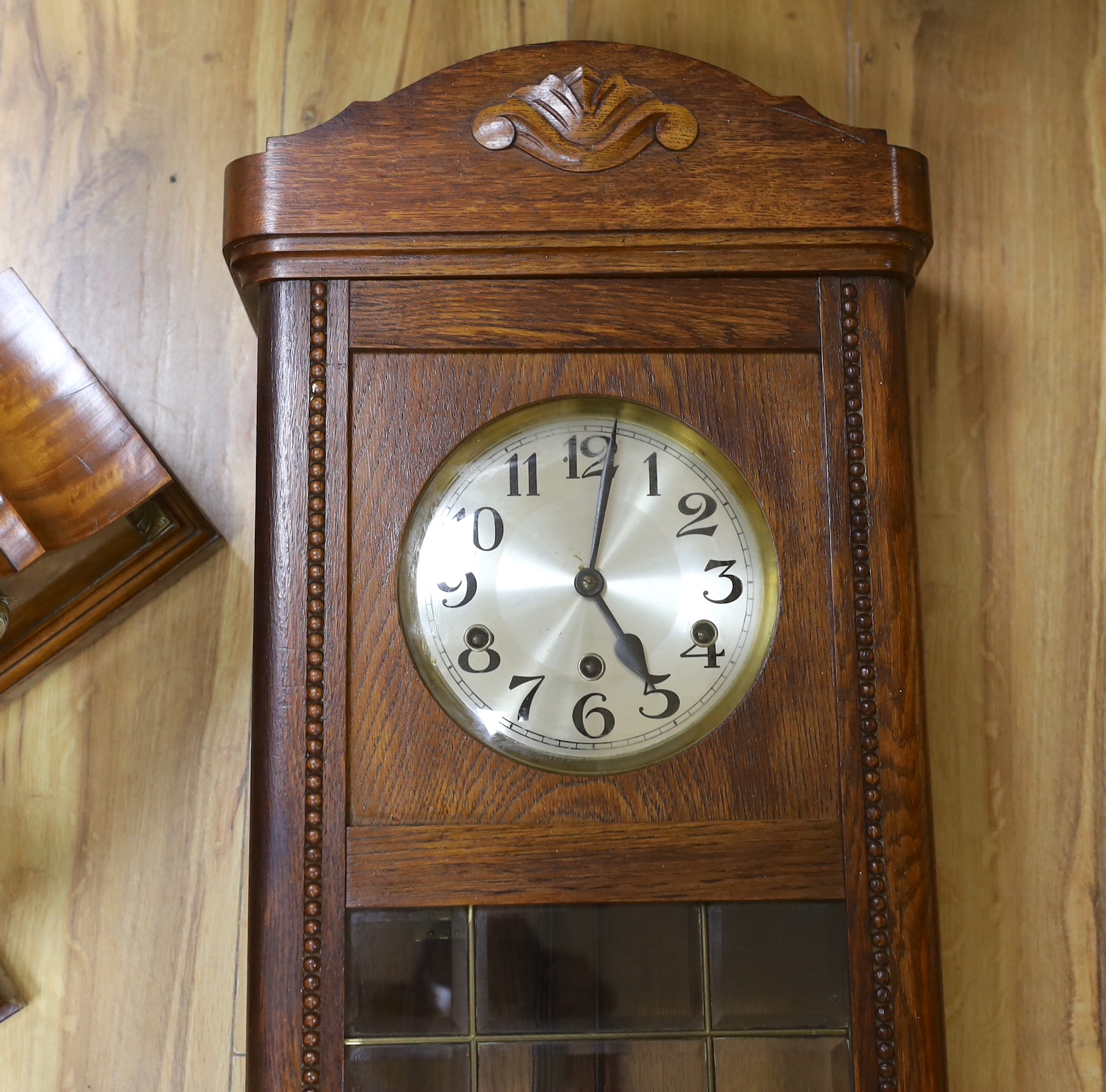 Two mantel clocks including an Edwardian inlaid balloon example and a wall clock, largest 80cm high